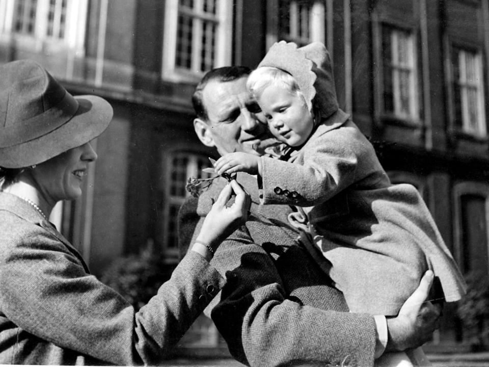 Denmark's King Frederik IX and Queen Ingrid holding their two year old and eldest daughter Pincess Margrethe who will become Queen Margrethe II.