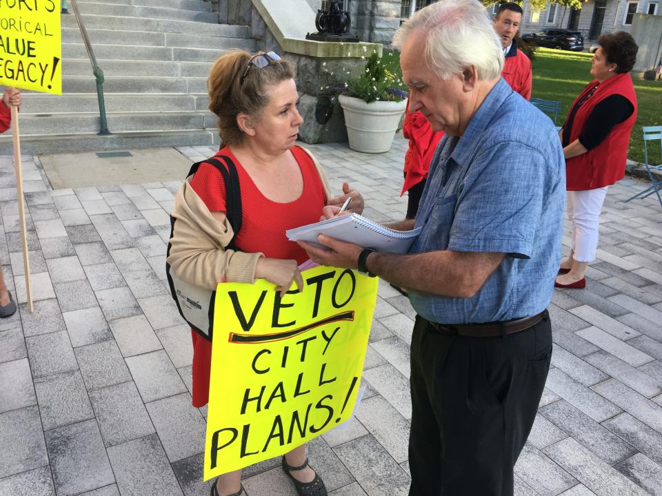 Newport resident Terry Thoelke speaks with Daily News reporter Sean Flynn during a rally at City Hall in 2019.