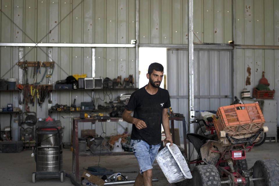 Yinon Levi works on his farm in the South Hebron Hills, West Bank, Sunday, May 12, 2024. Levi said he wants to expand agriculture at the farm, founded in 2021. (AP Photo/Maya Alleruzzo)