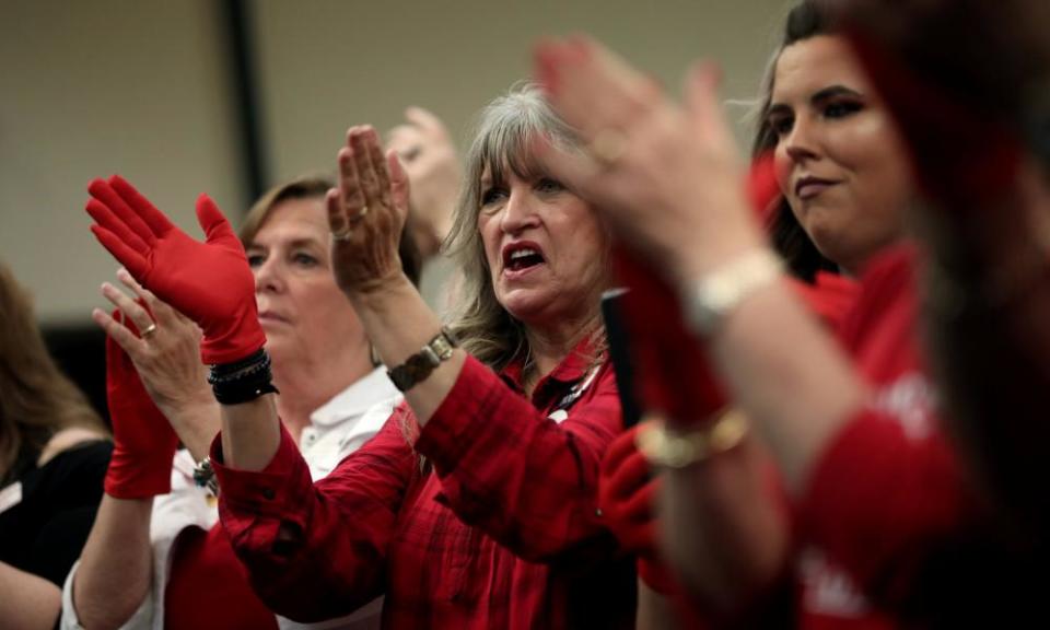 Supporters of Senator Ted Cruz applaud wearing ‘Red Wave’ gloves at a campaign rally in Victoria, Texas, on 3 November.