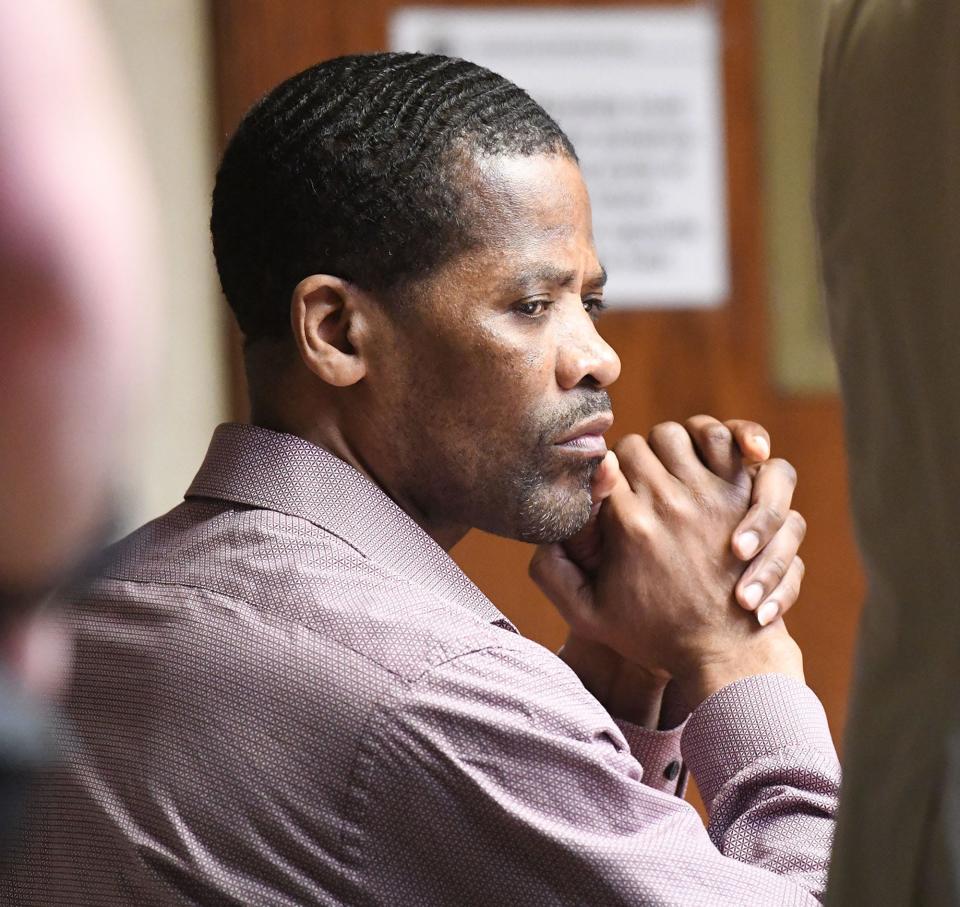 Jean Jacques, accused of killing 25-year-old Casey Chadwick in Norwich seven years ago listens to his attorney Sebastian DeSantis Wednesday during his murder retrial at New London Superior Court.