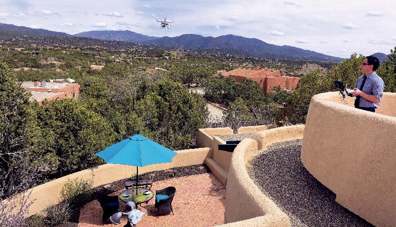 Brian Tercero, of Keller Williams Realty, uses a drone to create a high definition video of a property that he is trying to sell for a client, April 18, 2014. He feels video footage from a drone can better convey the appeal of a property than standard marketing photos. (AP Photo/The Santa Fe New Mexican, Clyde Mueller)