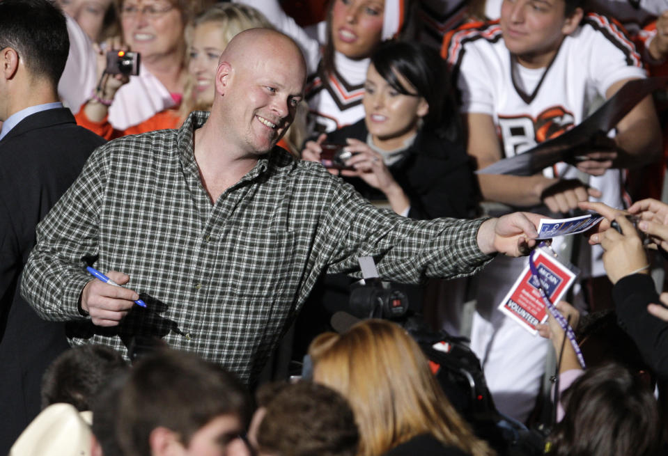 FILE - Joe Wurzelbacher, also known as "Joe the Plumber," signs autographs after appearing at a rally with Republican vice presidential candidate, Alaska Gov. Sarah Palin, at Bowling Green University in Bowling Green, Ohio, Oct. 29, 2008. Wurzelbacher, who was thrust into the political spotlight as “Joe the Plumber” after questioning Barack Obama about his economic policies during the 2008 presidential campaign, has died, his son said Monday, Aug. 28, 2023. He was 49. His oldest son, Joey Wurzelbacher, said his father died Sunday, Aug. 27, in Wisconsin after a long illness. (AP Photo/Amy Sancetta, File)