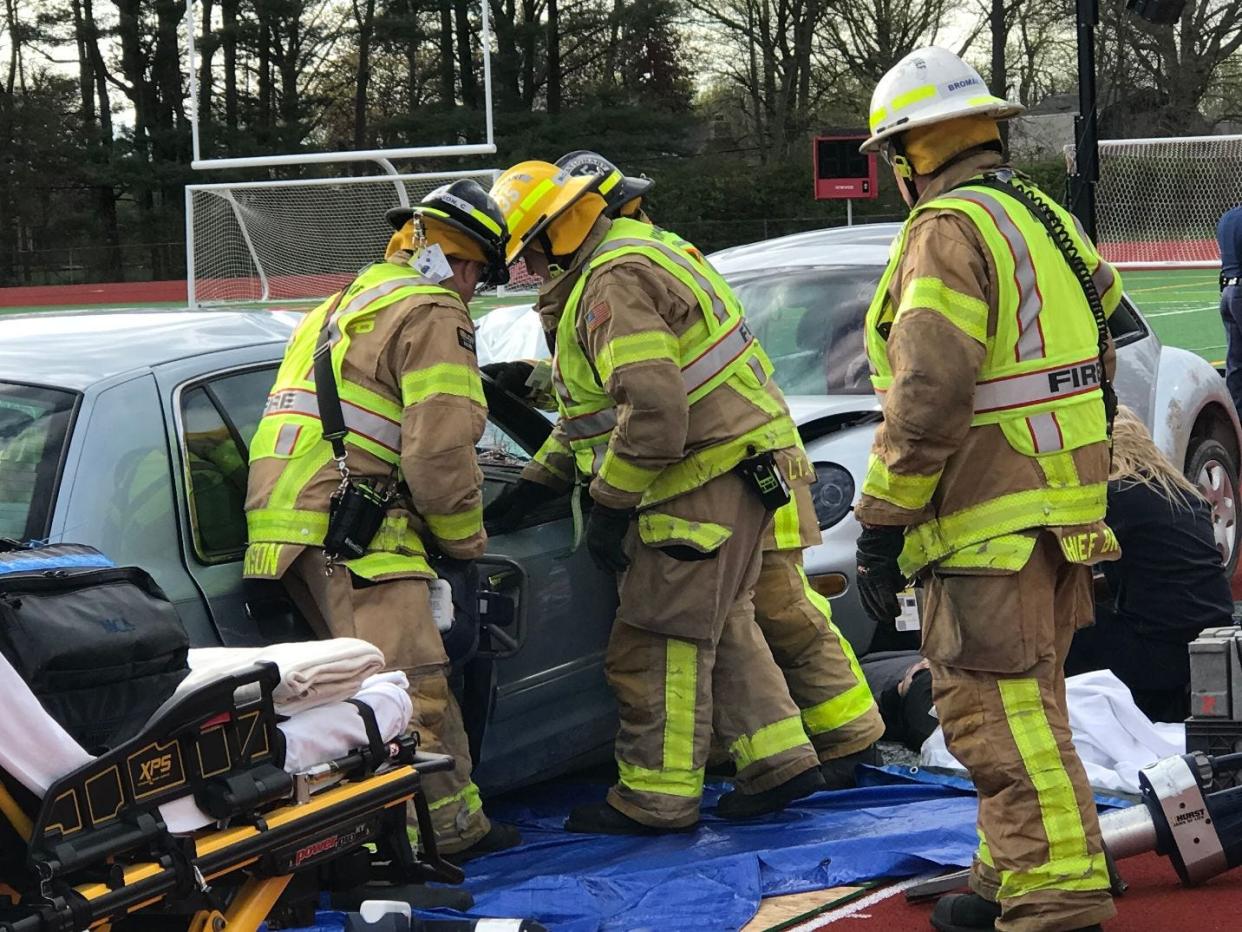 First responders work to free Tess Eshenroder, who was trapped in a Grand Marquis during a mock crash and rescue put on Thursday morning at Monroe High School.