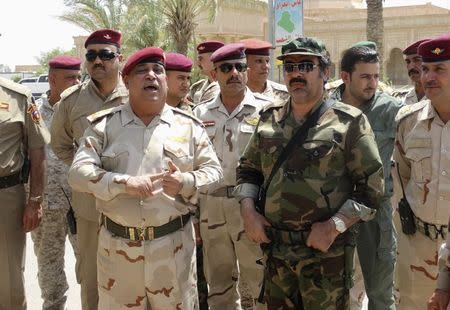 Sunni tribal leader Sheikh Ahmed Abu Risha (R) and General Rashid Flaih, Operations Chief of Anbar Province (L) visit a reinforcement operation by Iraqi security forces for Anbar Province, in Ramadi June 17, 2014. REUTERS/Osama Al-dulaimi