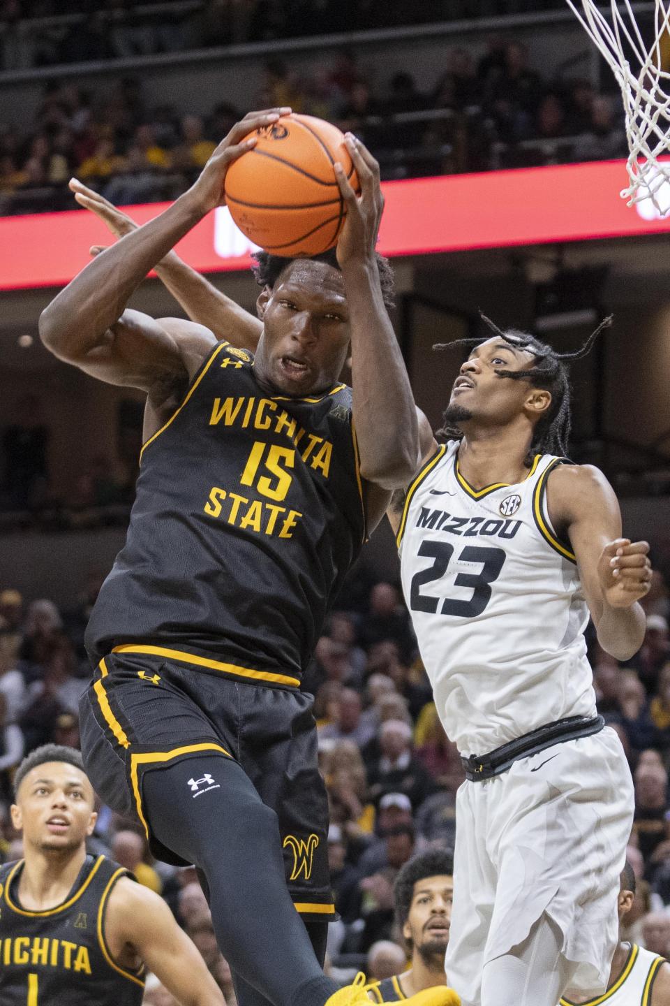 Wichita State's Quincy Ballard, left, pulls down a rebound over Missouri's Aidan Shaw, right, during the second half of an NCAA college basketball game Sunday, Dec. 3, 2023, in Columbia, Mo. (AP Photo/L.G. Patterson)