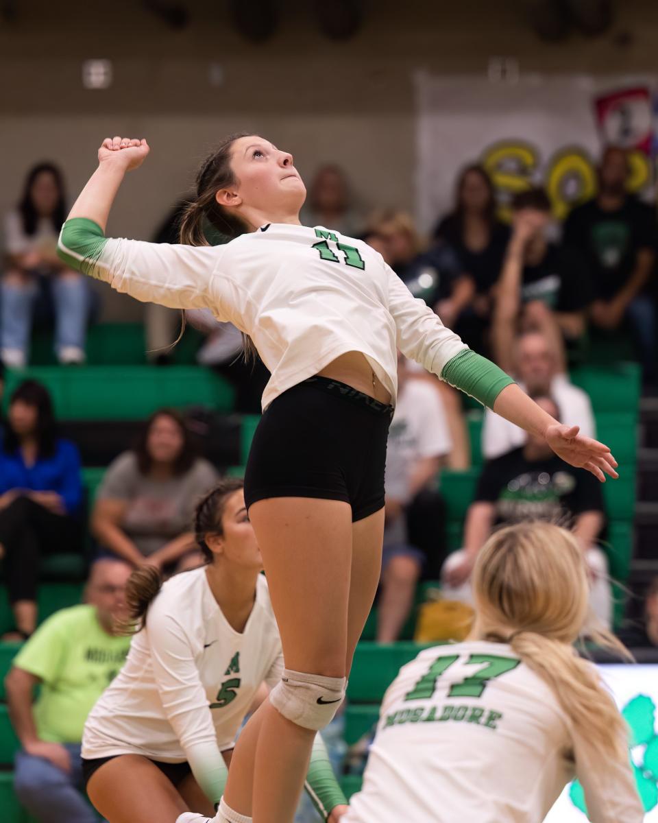 Mogadore's Addison Gerring jumps up to spike the ball during a high school volleyball game against the Rootstown Rovers in Mogadore on Tuesday, Sept. 20.