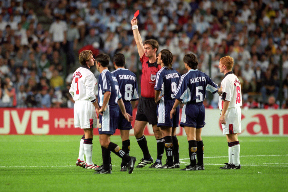 **Embargoed until 0001 May 2, 2020** File photo dated 30-06-1998 of England's David Beckham (L) is given the red card by Danish referee Kim Milton Nielsen, after a foul on Argentina's Diego Simeone during their France '98 World Cup second round match held in St Etienne. argentina won the match 4-3 on penalties (2-2 after extra time).