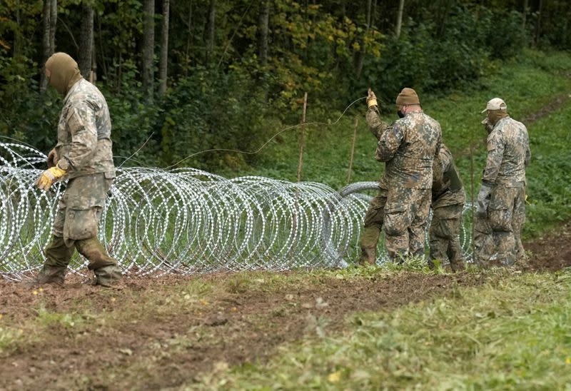 FILE PHOTO: Latvian army start to build temporary barbed wire fence on the Latvian-Belarus border near Robeznieki