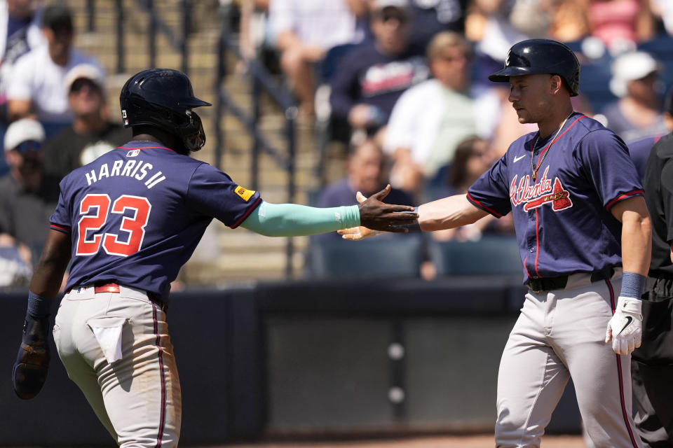 Atlanta Braves' Michael Harris II (23) celebrates with teammate Jarred Kelenic, right, after they scored in the first inning of a spring training baseball game against the New York Yankees Sunday, March 10, 2024, in Tampa, Fla. (AP Photo/Charlie Neibergall)