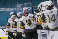 Vegas Golden Knights defenseman Alex Pietrangelo, middle, is congratulated by teammates after scoring against the San Jose Sharks during the first period of an NHL hockey game in San Jose, Calif., Wednesday, May 12, 2021. (AP Photo/Jeff Chiu)