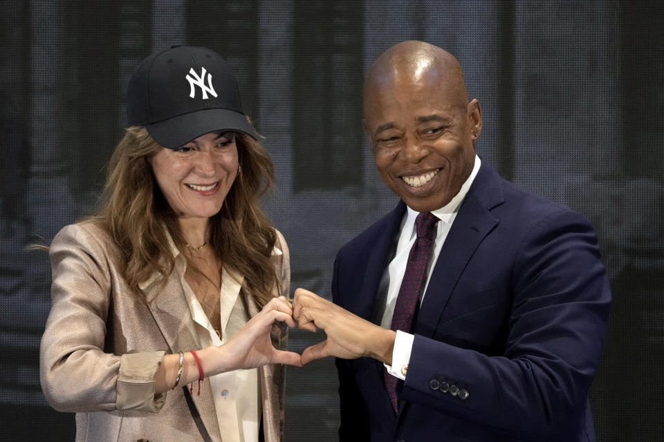 New York Mayor Eric Adams, right, and AT&T Mexico CEO Monica Aspe gesture a heart sign after participating in a forum by the US - Mexico Foundation in Mexico City, Thursday, Oct. 5, 2023. (AP Photo/Eduardo Verdugo)