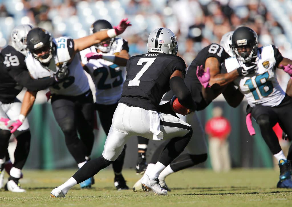 Oct 23, 2016; Jacksonville, FL, USA; A bad snap caused Oakland Raiders punter Marquette King (7) to have to run the ball on a punt play which resulted in a first down during the second half of  a football game against the Jacksonville Jaguars at EverBank Field. The Raiders won 33-16. Mandatory Credit: Reinhold Matay-USA TODAY Sports