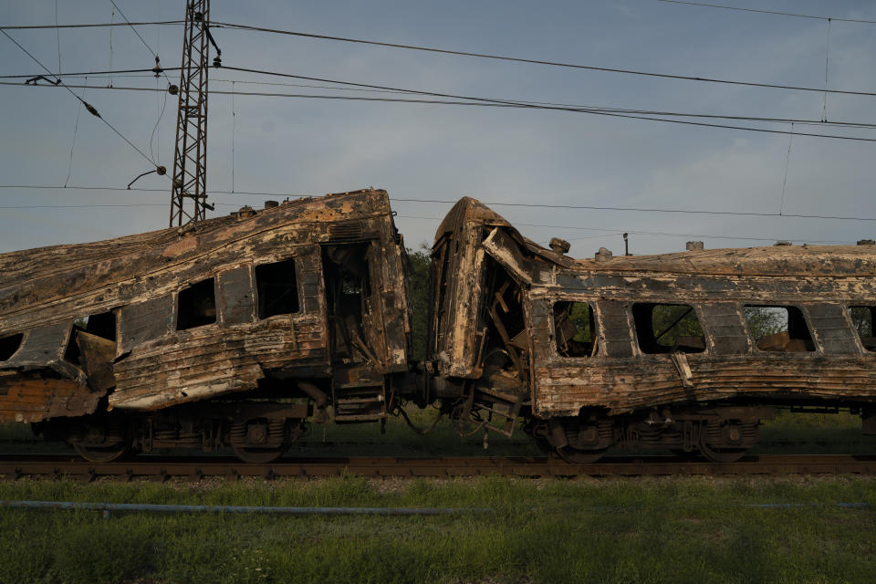 A heavily damaged train is seen at a train station after a Russian attack yesterday during Ukraine's Independence Day in the village Chaplyne, Ukraine, Thursday, Aug. 25, 2022. (AP Photo/Leo Correa)