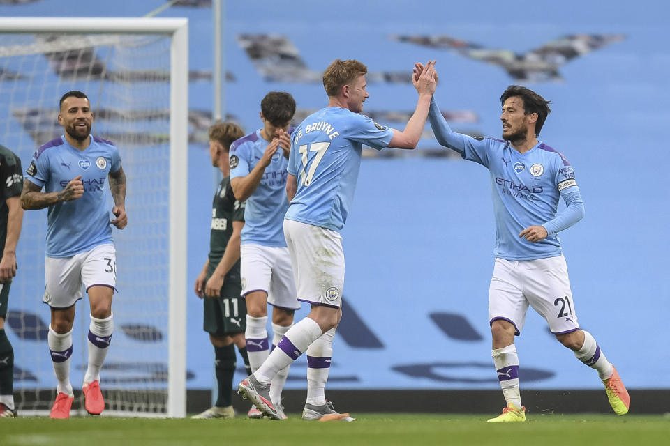 Manchester City's David Silva, right , celebrates after scoring a goal during the English Premier League soccer match between Manchester City and Newcastle at the Ethiad Stadium in Manchester, England, Wednesday, July 8, 2020. (Michael Regan/Pool via AP)