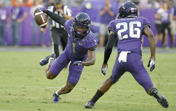 TCU cornerback Tre'Vius Hodges-Tomlinson (1) intercepts a pass as safety Bud Clark (26) looks on against Duquesne during the first half of an NCAA college football game Saturday, Sept. 4, 2021, in Fort Worth, Texas. (AP Photo/Ron Jenkins)