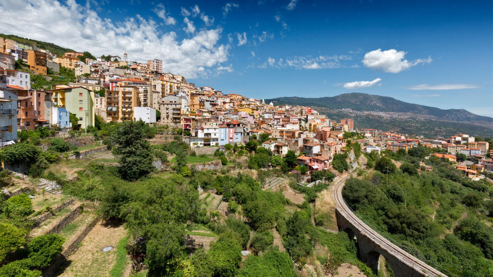 Distant cityscape in valley, Villagrande Strisaili, Ogliastra, Italy