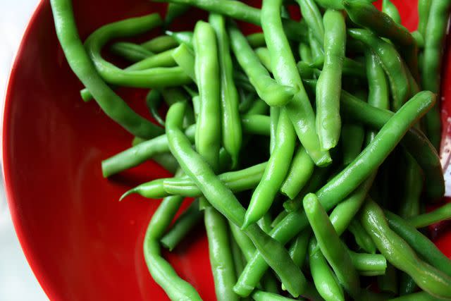 Carrie Anne Castillo/Moment/Getty Images Green Beans in a Red Bowl