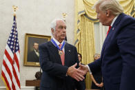 President Donald Trump shakes hands with auto racing great Roger Penske during a Presidential Medal of Freedom ceremony in the Oval Office of the White House, Thursday, Oct. 24, 2019, in Washington. (AP Photo/Alex Brandon)