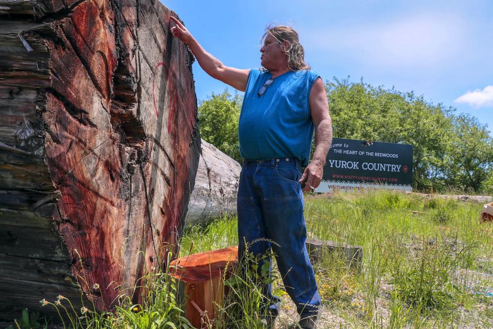 Dave Severns, a member of the Yurok Tribe, uses traditional methods to craft canoes from hollowed redwood trunks. <a href="https://www.gettyimages.com/detail/news-photo/klamath-ca-thursday-june-10-2021-the-yurok-tribe-offers-news-photo/1233879225" rel="nofollow noopener" target="_blank" data-ylk="slk:Robert Gauthier/Los Angeles Times via Getty Images;elm:context_link;itc:0;sec:content-canvas" class="link ">Robert Gauthier/Los Angeles Times via Getty Images</a>