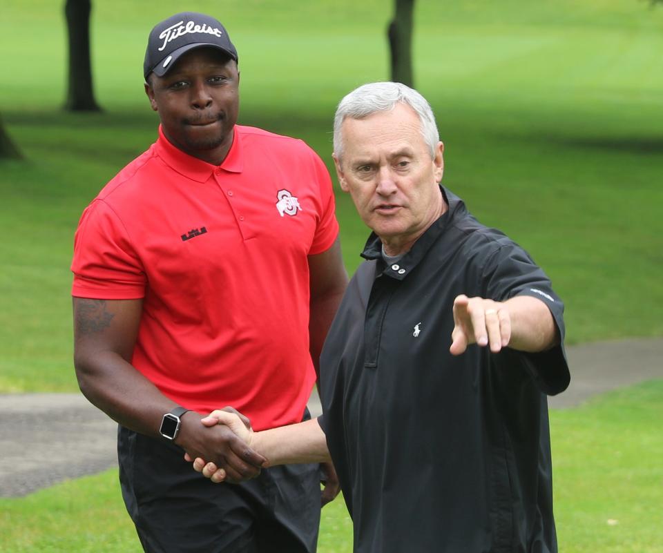 Former Ohio State football player Michael Doss listens to Jim Tressel on the 14th tee during the William White ALS fundraiser Monday at Union Country Club. (TimesReporter.com / Jim Cummings)