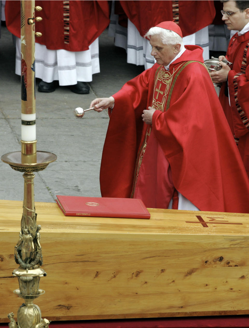 FILE - Then Cardinal Joseph Ratzinger, now Pope Benedict XVI, blesses the coffin containing the body of Pope John Paul II, during the funeral mass in St. Peter's Square at the Vatican, on April 8, 2005. When Cardinal Joseph Ratzinger became Pope Benedict XVI and was thrust into the footsteps of his beloved and charismatic predecessor, he said he felt a guillotine had come down on him. The Vatican announced Saturday Dec. 31, 2022 that Benedict, the former Joseph Ratzinger, had died at age 95. (AP Photo/Andrew Medichini, File)