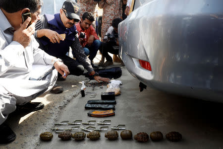 Members of the bomb disposal unit, checking the exlosives recovered from a bag, after an attack on the Chinese consulate, in Karachi, Pakistan November 23, 2018. REUTERS/Akhtar Soomro