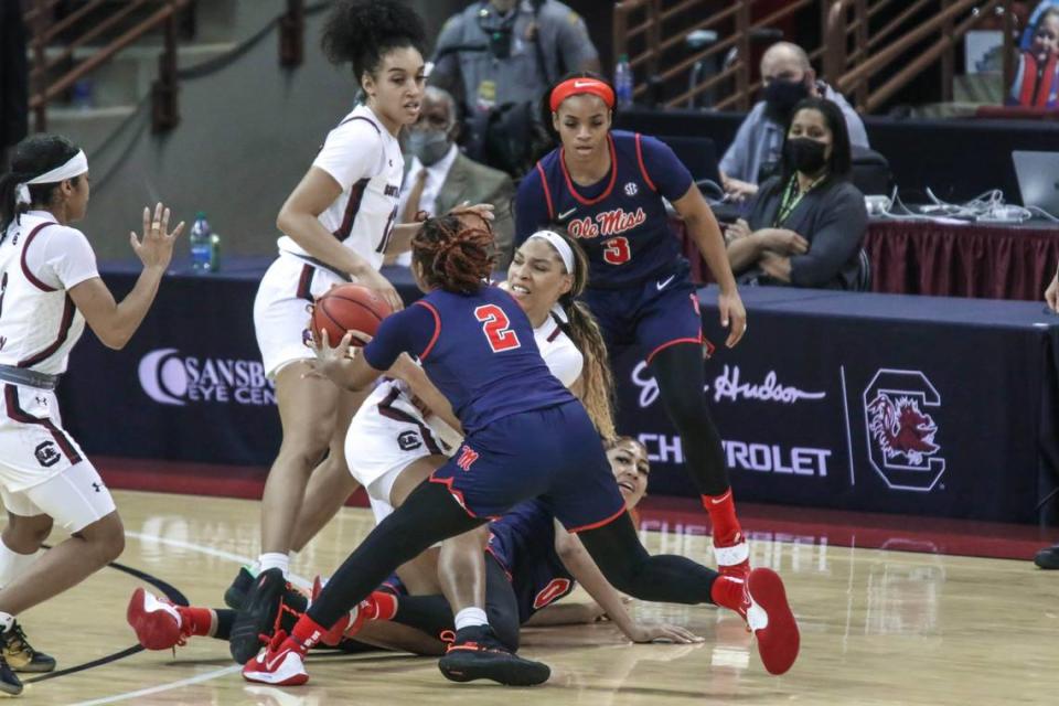 South Carolina Gamecocks forward Victaria Saxton (5) grapples for a loose ball with Ole Miss forward Shakira Austin (0) and guard Mimi Reid (2) during the first half of action in the Colonial Life Arena in Columbia, S.C.