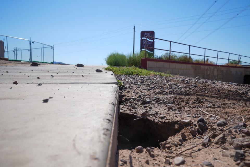 A section of the Laveen Area Conveyance Channel shows erosion going nearly three feet deep on Oct. 1, 2022, in Laveen Village. Rebecca Perrera serves on the HOA board and often uses the canal, which has been damaged by erosion due to neglect, to commute to Starbucks and spend time with her family. She, along with residents, local schools and town committees, are pushing for city funding from the 2023 GO Bond to implement safe pedestrian crossings and fix irrigation issues and erosion on the path.