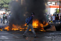 Demonstrators build a fire barricade while clashing with riot security forces during a rally against President Nicolas Maduro in Caracas, Venezuela, May 24, 2017. REUTERS/Carlos Barria