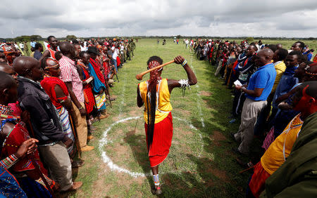 A Maasai moran throws a traditional club, known as rungu, during the 2018 Maasai Olympics at the Sidai Oleng Wildlife Sanctuary, at the base of Mt. Kilimanjaro, near the Kenya-Tanzania border in Kimana, Kajiado, Kenya December 15, 2018. REUTERS/Thomas Mukoya