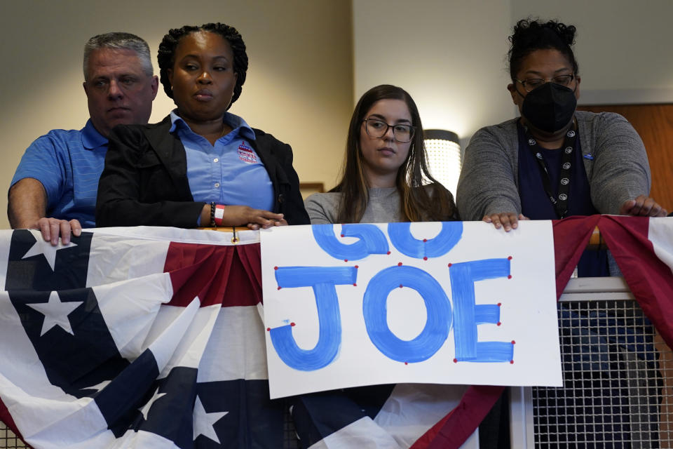 FILE - People listen as President Joe Biden speaks about the economy to union members at the IBEW Local Union 26, Feb. 15, 2023, in Lanham, Md. (AP Photo/Evan Vucci, File)