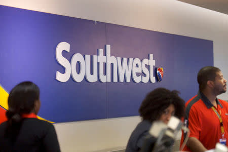 A Southwest Arlines logo is seen as employees check in travelers at the Philadelphia International Airport in Philadelphia, Pennsylvania U.S. April 17, 2018. REUTERS/Mark Makela