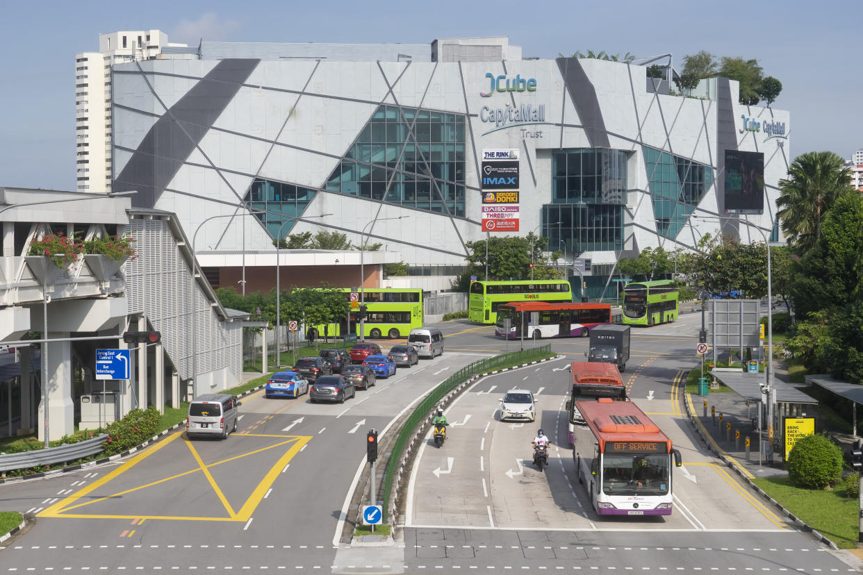 Singapore, Singapore - November 6, 2021: Vehicles and public buses before the JCube shopping mall in Jurong East.