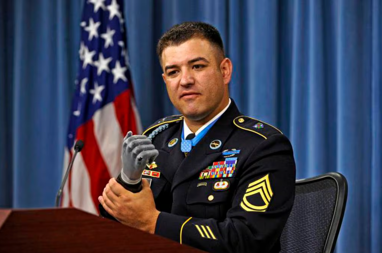 During a press conference following his induction into the Pentagon's Hall of Heroes, July 13, 2011, Medal of Honor recipient Army Sgt. 1st. Class Leroy Petry describes in detail the combat action of May 26, 2008, near Paktya, Afghanistan, during which he distinguished himself by conspicuous gallantry in saving the lives of two fellow Rangers. Petry's right hand was traumatically amputated during the fight and he now uses a state-of-the-art prosthesis, which allows him amazing dexterity. DoD photo by R. D. Ward (Released)