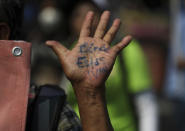 A person's his hand reads in Spanish "Where are you Ivan?" during a march in remembrance of those who have disappeared, on Mother's Day in Mexico City, Monday, May 10, 2021. (AP Photo/Fernando Llano)