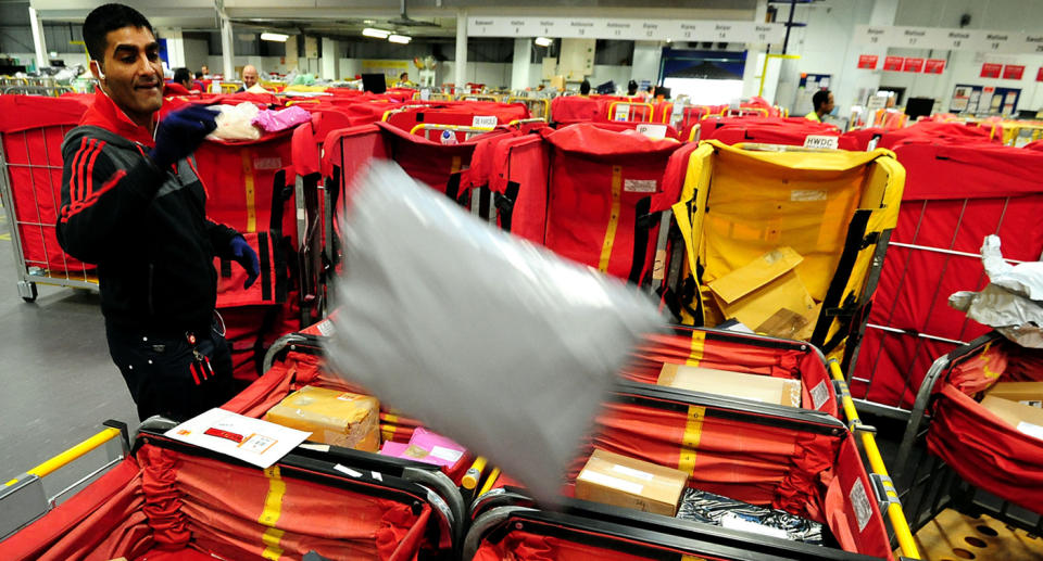 A worker sorting parcels in the mail room