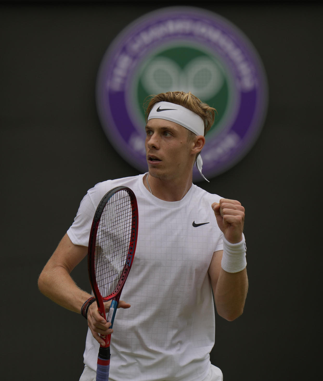 Canada's Denis Shapovalov celebrates breaking Russia's Karen Khachanov's serve in the fifth set during the men's singles quarterfinals match on day nine of the Wimbledon Tennis Championships in London, Wednesday, July 7, 2021. (AP Photo/Alastair Grant)