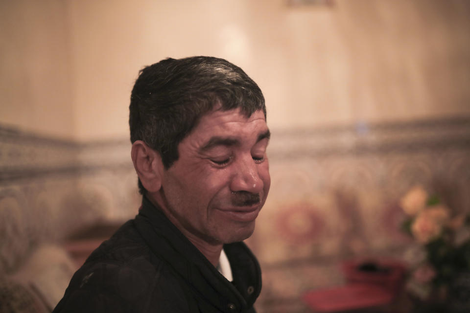 Belhussein Abdelsalam, a Charlie Chaplin impersonator reacts, while speaking of his past life, in his home in Sale, near Rabat, Morocco, Tuesday, March 23, 2021. When 58-year-old Moroccan Belhussein Abdelsalam was arrested and lost his job three decades ago, he saw Charlie Chaplin on television and in that moment decided upon a new career: impersonating the British actor and silent movie maker remembered for his Little Tramp character. (AP Photo/Mosa'ab Elshamy)