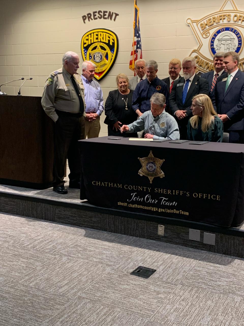 As Chatham County Sheriff John Wilcher looks on, Governor Brian Kemp signs S.B. 92, which establishes a Prosecuting Attorneys Oversight Commission, at the Chatham County Detention Center, on May 5, 2023.