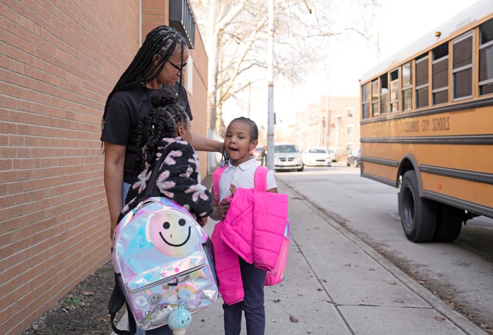 Nikia Gales meets her daughters Payton Stewart, 9, and Skylar Stewart, 6, at the school bus stop in March.