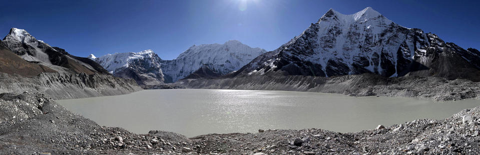 In this photo taken in October 2009 and released by WWF, Imza Lake lies near the foothills of Mount Everest, near legendary mountaineer Apa Sherpa's old home in Nepal. Apa used to circle along a track skirting the water's edge but the trails have long since disappeared underwater. Apa, who has scaled the world's highest mountain a record 21 times, is on a quest to draw attention to the danger of more devastating floods as glacial melt caused by climate change fills mountain lakes to the bursting point. (AP Photo/WWF, Steve Morgon) EDITORIAL USE ONLY