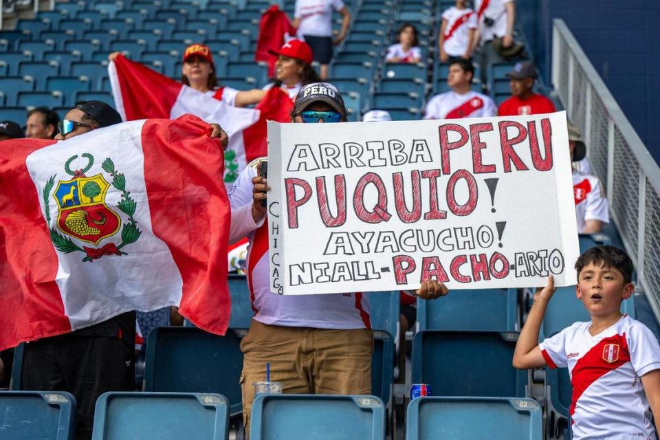 Peru fans hold up signs before a a Group A Copa America match between Canada and Peru at Children’s Mercy Park.