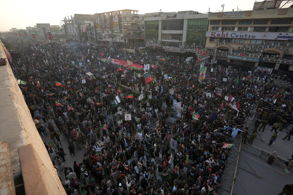 Supporters of Pakistan's former Prime Minister Imran Khan's 'Pakistan Tehreek-e-Insaf' party attend a rally, in Rawalpindi, Pakistan, Saturday, Nov. 26, 2022. Khan said Saturday his party was quitting the country's regional and national assemblies, as he made his first public appearance since being wounded in a gun attack earlier this month. (AP Photo/Anjum Naveed)