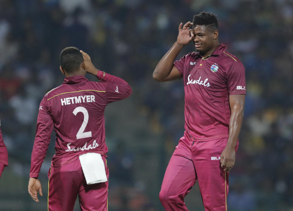 West Indies' bowler Oshane Thomas, right, gestures after taking the wicket of Shehan Jayasuriya during their first Twenty20 cricket match in Pallekele, Sri Lanka, Wednesday, March 4, 2020. (AP Photo/Eranga Jayawardena)