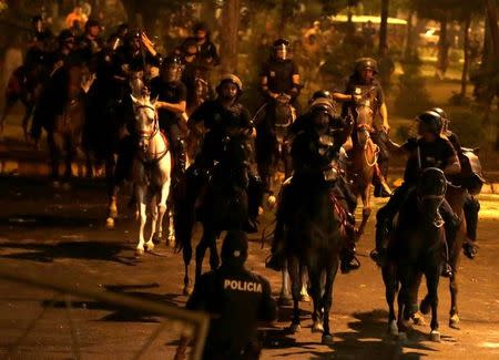 Police on horseback are seen during a demonstration against a possible change in law to allow for presidential re-election in front of the Congress building in Asuncion, Paraguay, March 31, 2017. REUTERS/Jorge Adorno