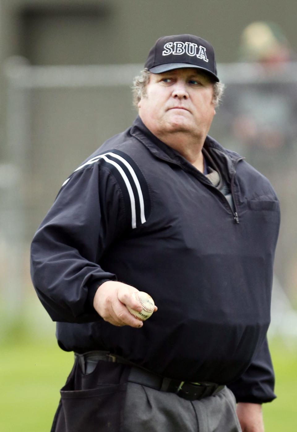 John “Cheeseburger” Witherspoon is shown officiating a baseball game in 2013.