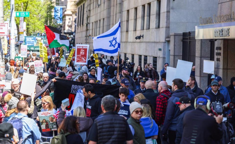Pro-Palestine and pro-Israel demonstrators protest outside of Columbia University on Monday as tensions rise on the college campus in New York (AFP via Getty Images)