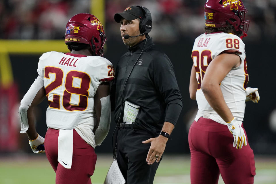 Iowa State coach Matt Campbell congratulates running back Breece Hall (28) and tight end Charlie Kolar (88) during the first half of the team's NCAA college football game against UNLV on Saturday, Sept. 18, 2021, in Las Vegas. (AP Photo/John Locher)