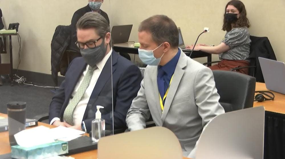 In this image from video, defense attorney Eric Nelson, left, and defendant, former Minneapolis police officer Derek Chauvin listen to Hennepin County Judge Peter Cahill read instructions to the jury before closing arguments, Monday, April 19, 2021, in the trial of Chauvin at the Hennepin County Courthouse in Minneapolis. (Court TV via AP, Pool)